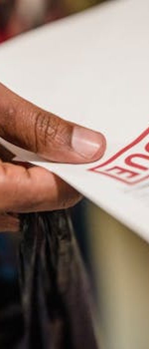 A close-up of a hand holding a document with a 'Past Due' stamp, highlighting financial urgency.